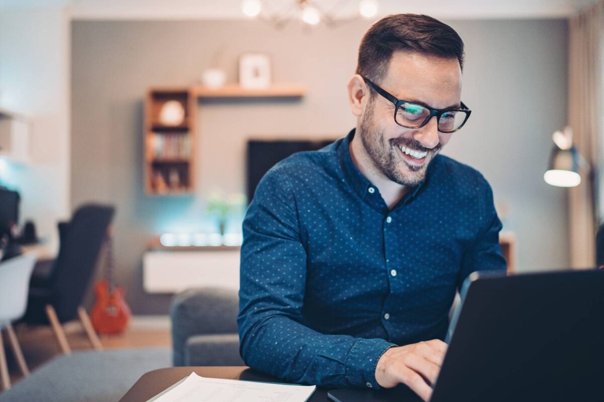 Image of a person working on their laptop at home